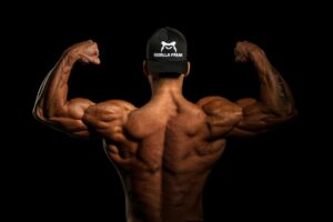 man flexing his back and biceps from behind