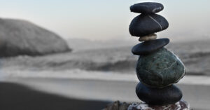 stones stacked in harmony overlooking water