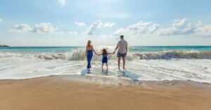 a family holding hands on a beach