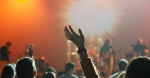 a group of people with their hands up in faith