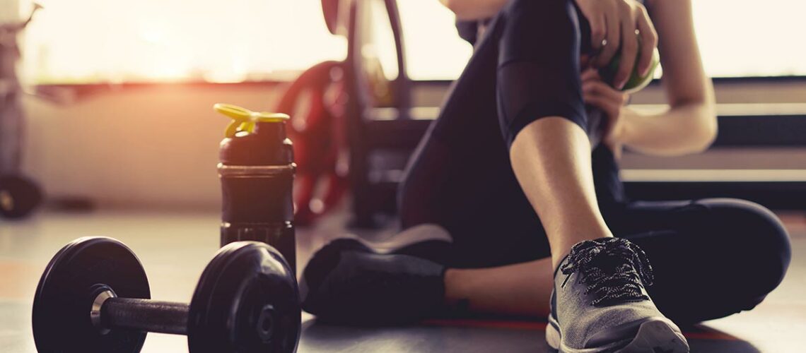 Woman sitting after fitness training