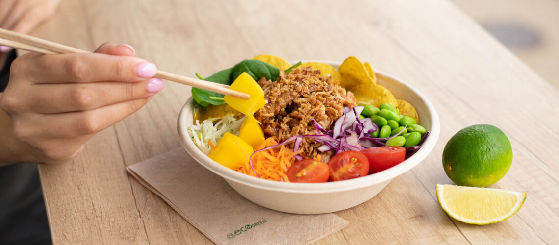 Someone eating an energy bowl with chop sticks.