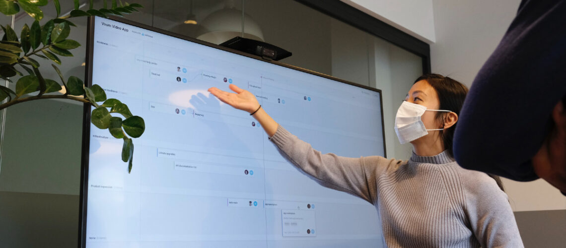 teacher pointing at a white board