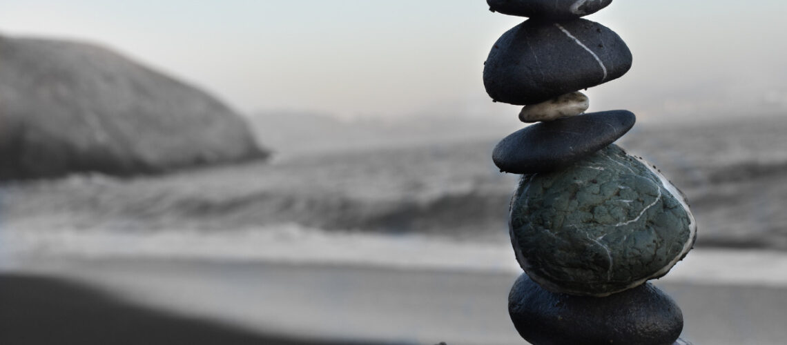 stones stacked in harmony overlooking water