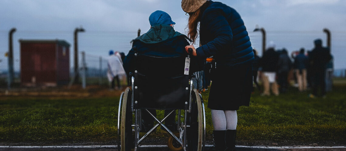 a person talking to another person in a wheelchair