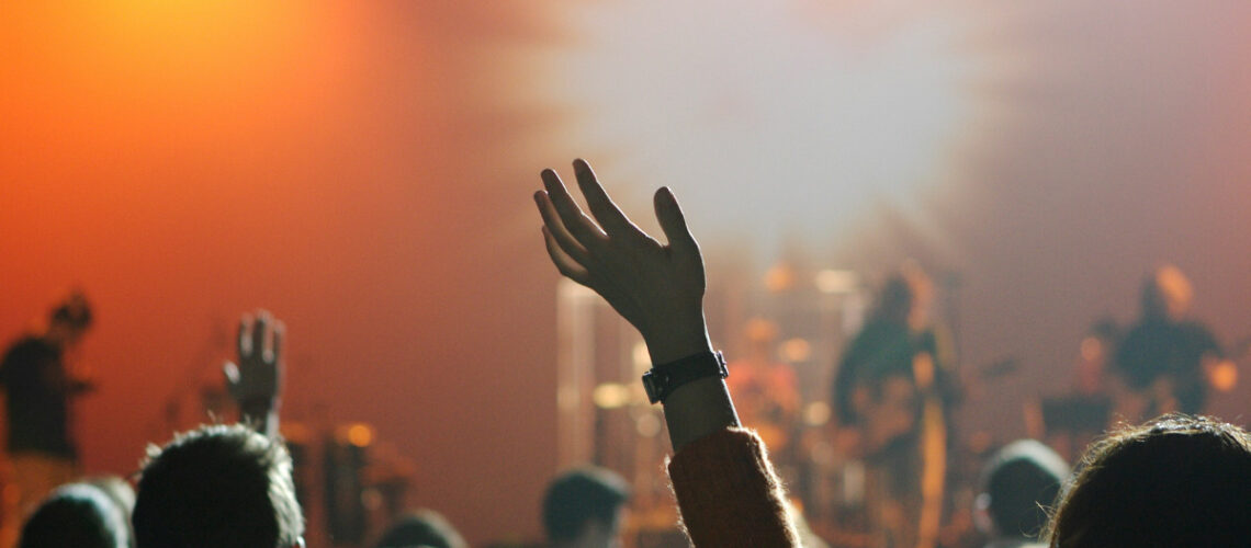 a group of people with their hands up in faith
