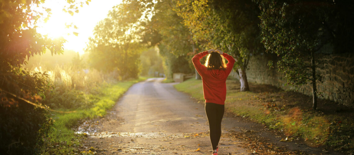 a woman walking down a hiking trail