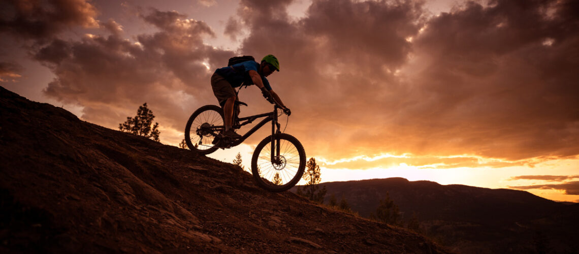 Individual mountain biking at sunset.