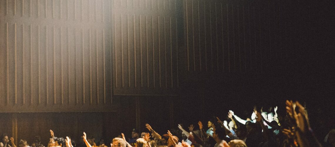 A crowd raising its hands