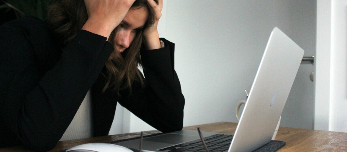 Stressed woman in from of a laptop