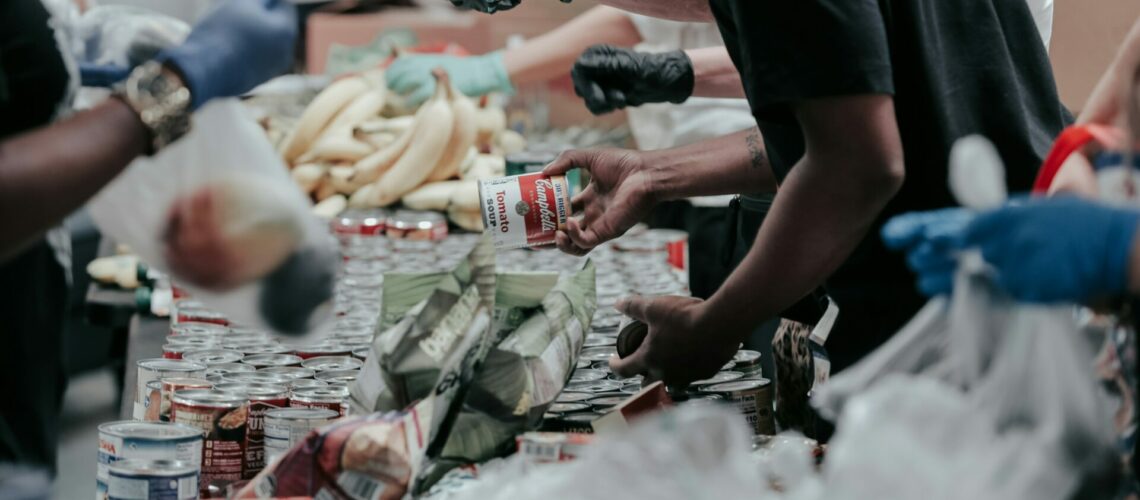 man in black t-shirt holding coca cola bottle