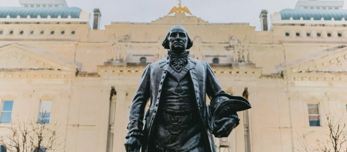 black statue of man in black coat